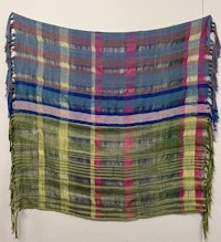 a colorful shawl hanging on a wall